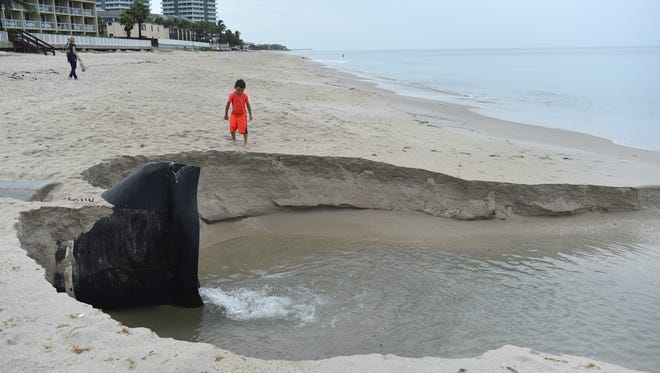 Jacoby Carrington, 6, of Alaska (Vero beach native), watches water drainage at Sexton Plaza in Vero Beach as it empties into an eroded area of beach, Monday July 31, 2017 while out with his grandmother Susan Carrington (left), of North Carolina. The Carrington family returned to Vero Beach for a visit as Tropical Storm Emily formed in the Gulf of Mexico Monday. "We're a little bit shocked, it wasn't here yesterday and suddenly we got a tropical storm," Susan Carrington said.