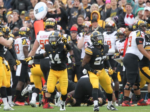 Iowa's Desmond King (14) and Jordan Lomax (27) celebrate