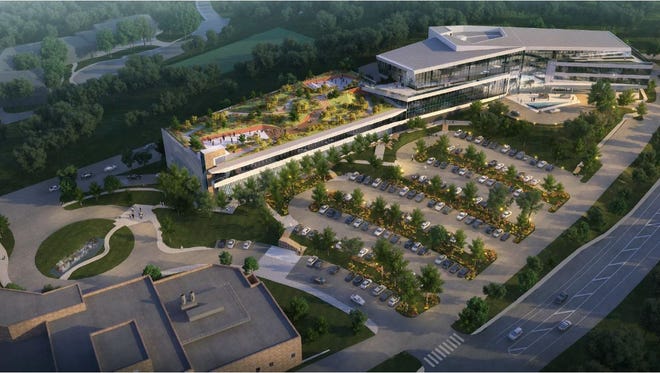 A rendering of the planned expansion of Incyte's headquarters off Augustine Cut Off is shown. The project includes a parking garage with green roof to the left and office space in the attached building to the right.