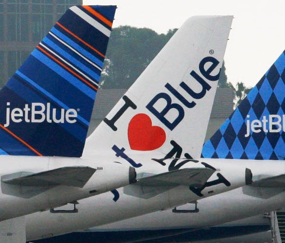JetBlue planes, each with distinctive tail art, are seen at the JetBlue terminal at Long Beach Airport in Long Beach, Calif., on Oct. 25, 2011.