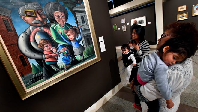 Teresa Merino holds her granddaughter Abigail Cathey, 3, as she and her daughter Elizabeth Cathey, holding her six-month-old daughter Amelia, study a painting at the Grace Museum Saturday Jan. 20, 2018. "The Fine Art of Collecting: Selections from the Judge and Mrs. B. Michael Chitty Collection" is on exhibit until April 14.