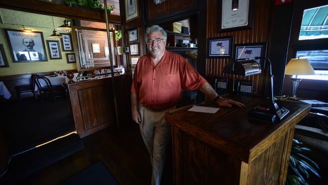 Jim McCoy of Binghamton, the owner of Number 5, stands at the host's table in this 2014 photo.