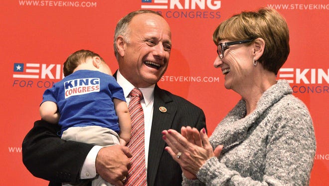 Rep. Steve King, R-Iowa, holds his 11-month grandson, Wallace Henry King, while standing on a podium with his wife, Marilyn, at his election watch party Tuesday, Nov. 4, 2014, in Sioux City, Iowa. King was running for re-election against Democratic challenger Jim Mowrer. (AP Photo/Sioux City Journal, Tim Hynds)