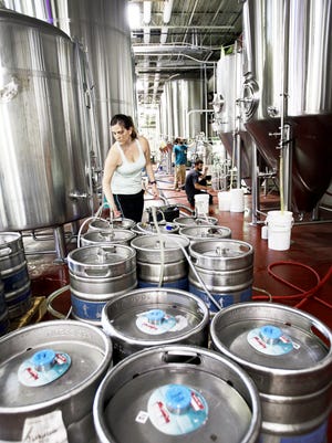 Sarah Gulotta fills kegs at Hi-Wire Brewing in this 2016 photo. Backers of a tax cut proposed for craft brewers like Hi-Wire say it would increase the number of jobs in the industry in the Asheville area and across the country.