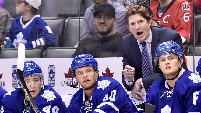 Toronto Maple Leafs coach Mike Babcock yells behind the bench against the Ottawa Senators on Monday, Sept. 21, 2015.
