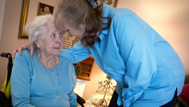 Barrie Page Hill, right, shares a moment with her mother Bobbie Wilburn, 79, in Arlington, Texas. Wilburn, who developed Alzheimer's disease, moved in with Hill.