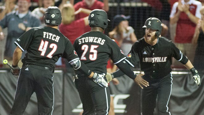 On deck batter U of L's Colby Fitch, left, congratulates U of L's Josh Stowers, center, who in turn congratulates U of L's Colin Lyman Stowers and Lyman score off of Logan Taylor's 2-rbi single to center-left.03 June 2017