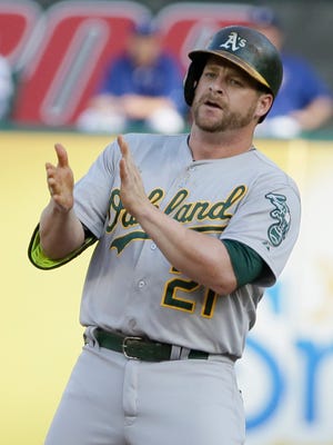 Oakland Athletics Stephen Vogt stands on second base after hitting an RBI double during the first inning of a baseball game against the Texas Rangers in Arlington, Texas, Wednesday, June 24, 2015. (AP Photo/LM Otero)  
