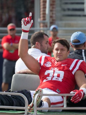 Ole Miss' John Youngblood was carted off the field in the first quarter of Saturday's game.