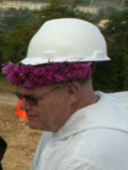 Father Jack Niland, wears a hard hat during the 2006 groundbreaking ceremony for the St. Fidelis Friary.