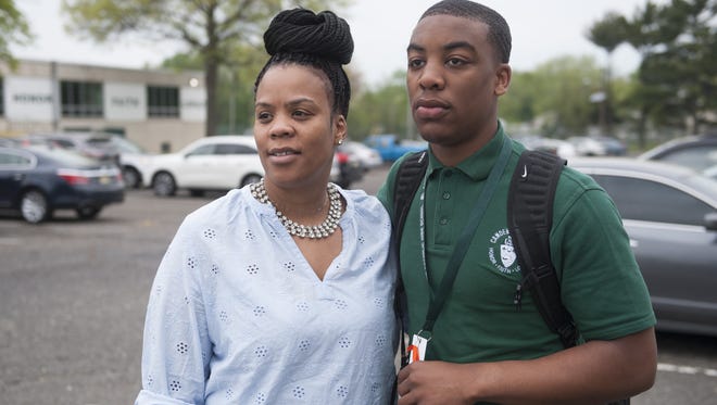 Camden Catholic High School sophomore Matthew Davis stands with his mother Stephanie Davis after a protest May 4 in support of former football coach Nick Strom.