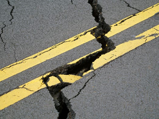 A crack stretches across Pohoiki Road near the Leilani