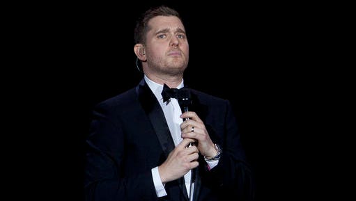 FILE - In this Jan. 31, 2014, file photo, Canadian singer Michael Buble performs during his concert at Palacio de los Deportes in Madrid, Spain. Buble announced on Nov. 4, 2016, that his 3-year-old son has been diagnosed with cancer and is undergoing treatment in the U.S.