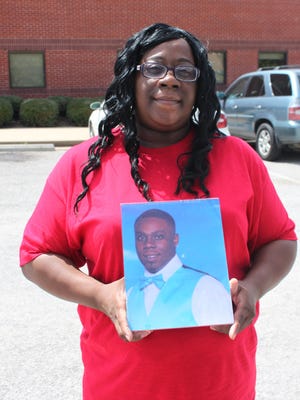 LaWanda Williams holds a portrait of her son Justin Williams after the sentencing of Dontavious Hendrix, who was convicted of Williams’ murder.