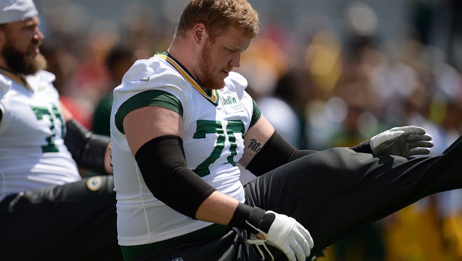 Green Bay Packers guard T.J. Lang (70) and his teammates stretch during OTAs at Ray Nitschke Field on Thursday, May 29, 2014. Evan Siegle/Press-Gazette Media