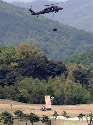A U.S. missile defense system called Terminal High Altitude Area Defense, or THAAD, is installed as U.S. helicopter flies over a golf course in Seongju, South Korea, May 2, 2017. The contentious U.S. anti-missile system is now operating and can defend against North Korean missiles, a South Korean official said.