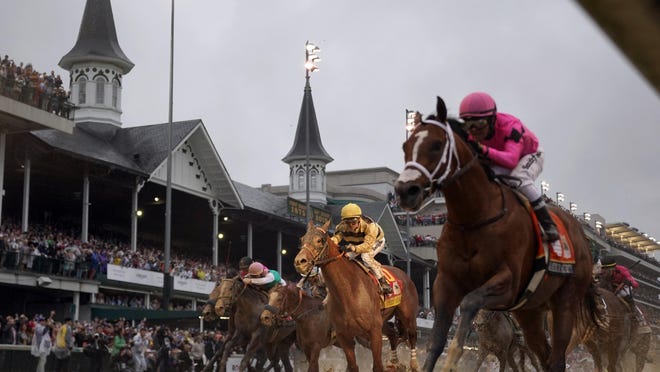 Luis Saez rides Maximum Security, right, across the finish line first against Flavien Prat on Country House during the 145th running of the Kentucky Derby at Churchill Downs in May 2019. This year, the Derby will be held in September, and spectators will be allowed, but with limitations.