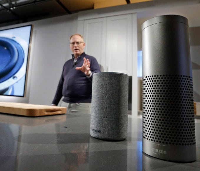 David Limp, senior vice president of Devices and Services at Amazon, displays a new Echo, left, and an Echo Plus during an event announcing several new Amazon products by the company, Wednesday, Sept. 27, 2017, in Seattle. Amazon says it is cutting t