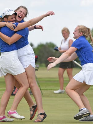 Sioux Falls O'Gorman's individual champion Emily Olson, left, is swarmed by teammates after she completed her round Tuesday at the South Dakota State Class AA Girls' Golf Tournament at Huron's Broadland Creek Golf Course. Olson led the Knights to the team title.