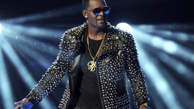 FILE - In this June 30, 2013 file photo, R. Kelly performs at the BET Awards in Los Angeles. Kelly has asked the Chicago judge to let him travel overseas for concerts in Dubai, saying he’s been unable to get work anywhere in the U.S. since his arrest on charges he sexually abused three minor girls and an adult woman. The request in a Wednesday filing says the R&B star will perform at up to five concerts in the oil-rich nation in the Middle East. A judge ordered Kelly to surrender his passport after his arrest last month on 10 counts of aggravated sexual abuse. (Photo by Frank Micelotta/Invision/AP, File)