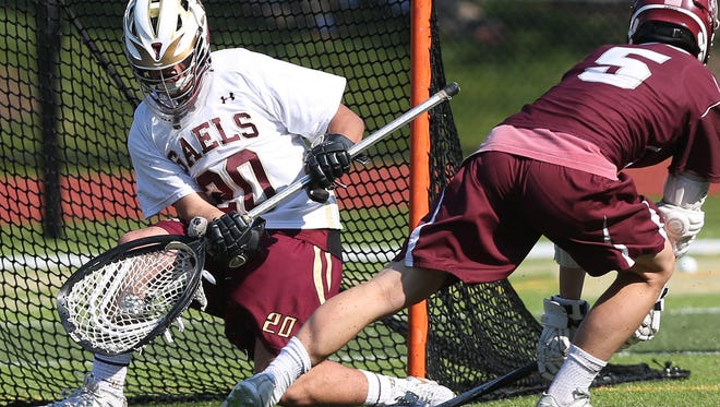 Iona's Joe Persico (20) stops a shot from Fordham's James Murray (5) during first half action during the CHSAA AA championship game at Iona Prep in New Rochelle May 17, 2017. Iona won the game 8-4.