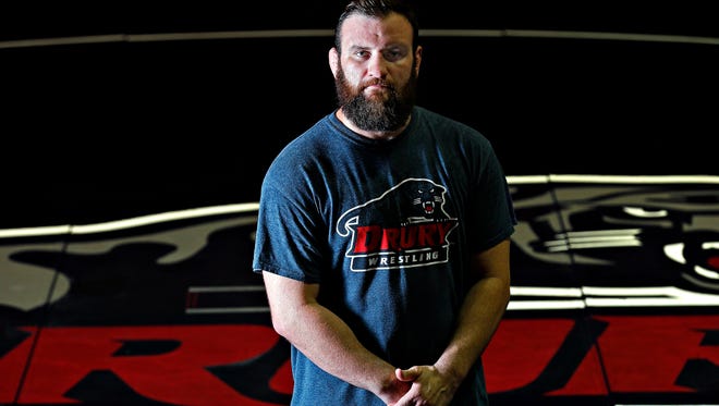 Head coach James Reynolds of Drury University's brand new wrestling team poses for a portrait at the university's Weiser Gym, where the team will compete, in Springfield, Mo. on July 26, 2016.