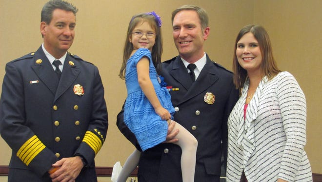 Ryan Asbrock is West Chester Township's newest fire lieutenant. He is pictured after his pinning ceremony Tuesday with Chief Rick Prinz, his wife, Liz, and daughter, Tess.