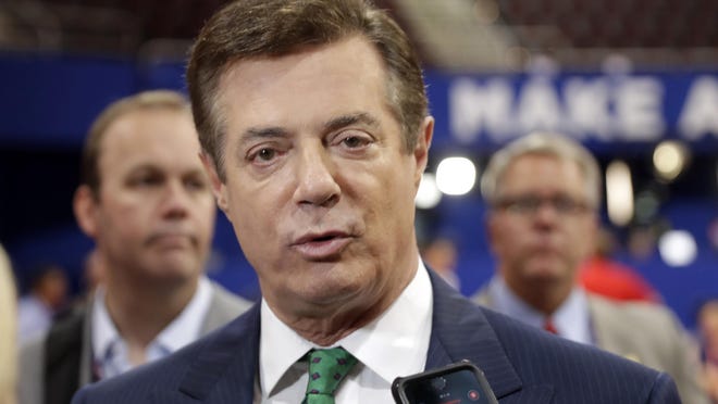 In this July 17, 2016 file photo, then-Donald Trump campaign chairman Paul Manafort talks to reporters on the floor of the Republican National Convention, in Cleveland.