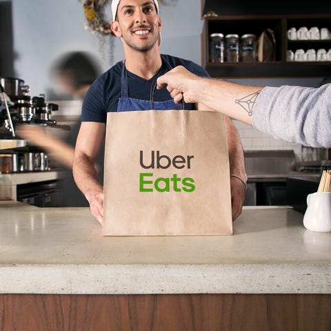 An Uber Eats courier picks up a meal.