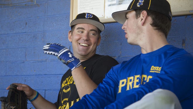 Prescott's Logan Carmick (in black) jokes with teammate Griffin Hays (R) before a baseball practice at Prescott High School on March 24, 2017 in Prescott, Ariz.