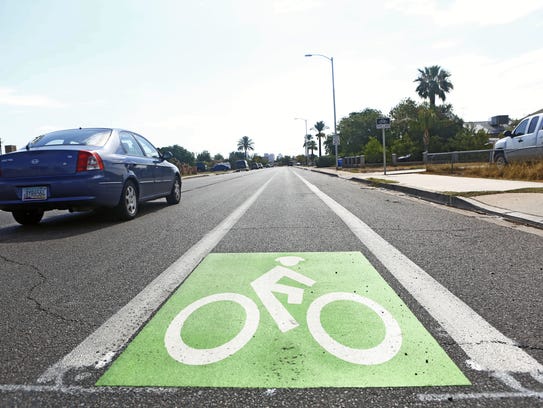 Signs mark the new bike lane on Jefferson Street in