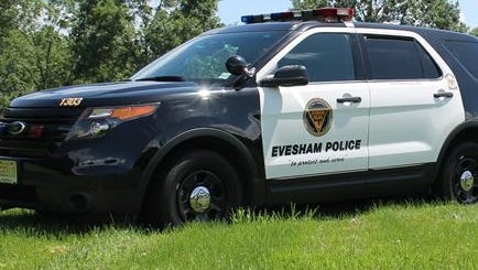 Evesham police said a suspected burglar crashed a stolen car in a wooded area and remained on the loose.