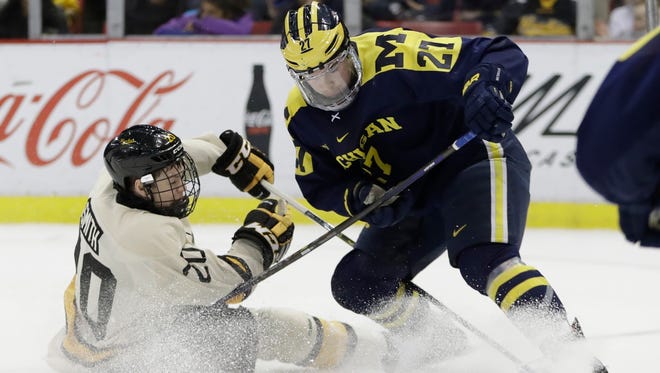 Nick Boka, right, completed a four-year collegiate career at the University of Michigan, helping the Wolverines to two NCAA tournament appearances and the Frozen Four in 2018.