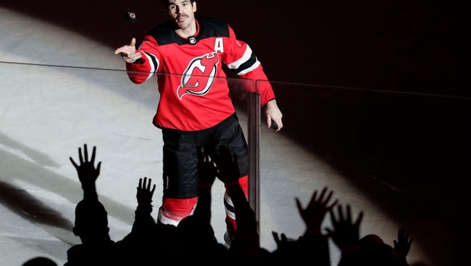 New Jersey Devils center Brian Boyle throws a puck toward fans after he helped the Devils defeat the Vancouver Canucks 3-2 during an NHL hockey game, Friday, Nov. 24, 2017, in Newark, N.J. (AP Photo/Julio Cortez)