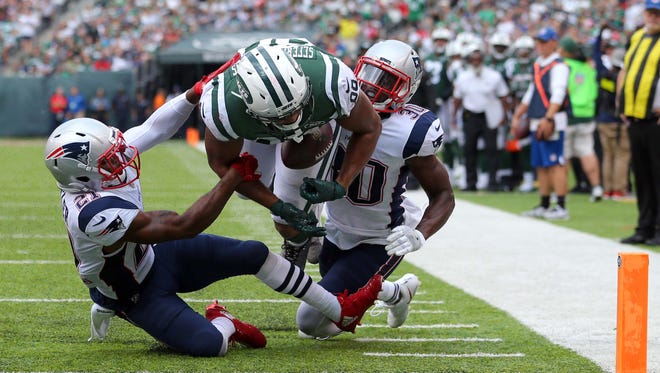 New York Jets tight end Austin Seferian-Jenkins (88) fumbles on the goal line against New England Patriots corner back Malcolm Butler (21) and New England Patriots safety Duron Harmon (30) during the fourth quarter at MetLife Stadium.