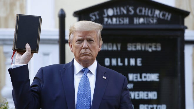 President Donald Trump holds a Bible outside St. John's Church across Lafayette Park from the White House.