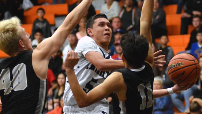 Oñate guard Ricky Lujan goes up with his left hand for a layup during third quarter action as the Knights took on Volcano Vista High on Friday night at Oñate High School.