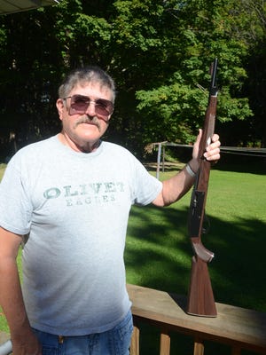 Richard Montague with his recovered rifle.