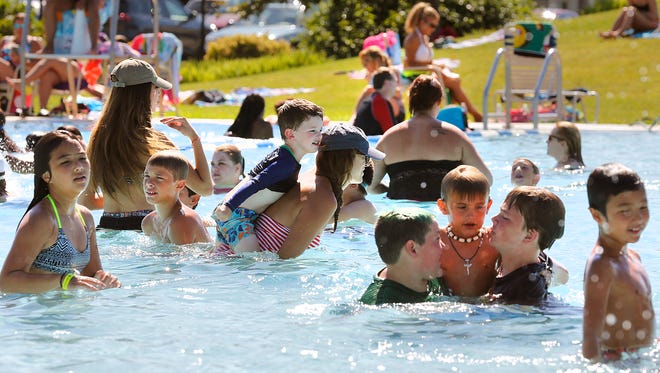 Temperatures in the 90s brought scores of people to the Fairgrounds Park Pool last Friday.