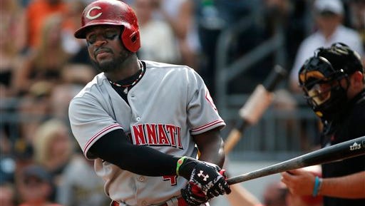 Cincinnati Reds' Brandon Phillips (4) looks for his signs during the first inning of a baseball game against the Pittsburgh Pirates in Pittsburgh Saturday, Aug. 30, 2014. The Pirates won 3-2. (AP Photo/Gene J. Puskar)