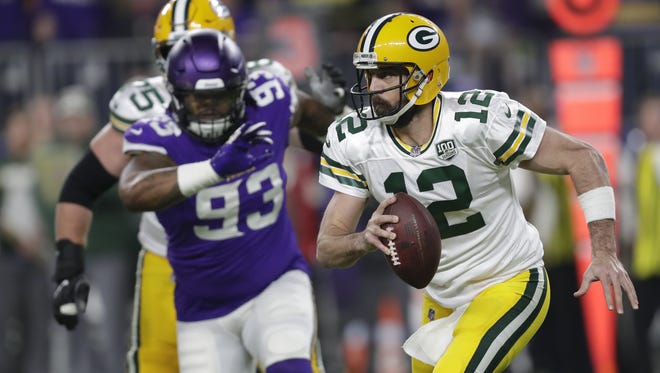 Green Bay Packers quarterback Aaron Rodgers (12) looks to pass on third down as he is pursued by Minnesota Vikings' Sheldon Richardson (93) in the first quarter during their football game Sunday, November 25, 2018, at U.S. Bank Stadium in Minneapolis, Minn.