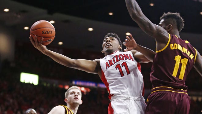 Arizona guard Allonzo Trier looks to the basket with pressure from Arizona State Savon Goodman against in Tucson, Ariz., on Wednesday, February 17, 2016.