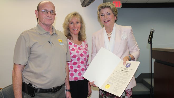 Robert King and Renay Rouse from the Florida Department of Health accept a proclamation from Commissioner Anne Scott announcing the Community Health Improvement Plan.