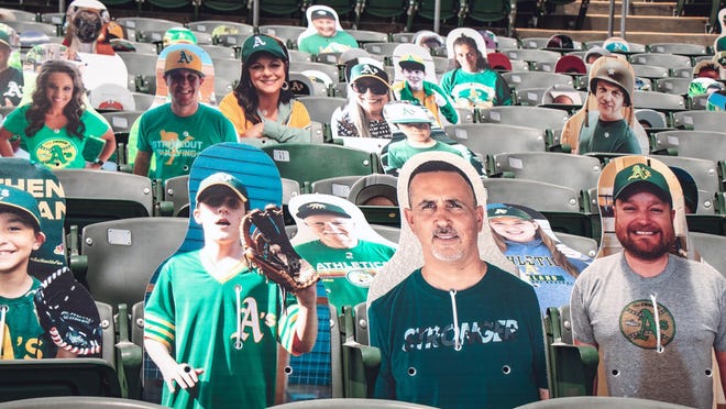 This July 15, 2020, photo provided by the Oakland Athletics baseball team shows fan cutouts in the stands at RingCentral Coliseum in Oakland, Calif., the Athletics home field. The Oakland Athletics offer a wide range of prices, but fans who pay $149 will have cutouts of their likenesses on the first-base side of RingCentral Coliseum plus an autographed photo from outfielder Stephen Piscotty. Proceeds benefit the Piscotty family foundation that's seeking a cure for ALS, the disease that killed Piscotty's mother. If a foul ball happens to hit a cutout, the owner receives a baseball signed by Piscotty.