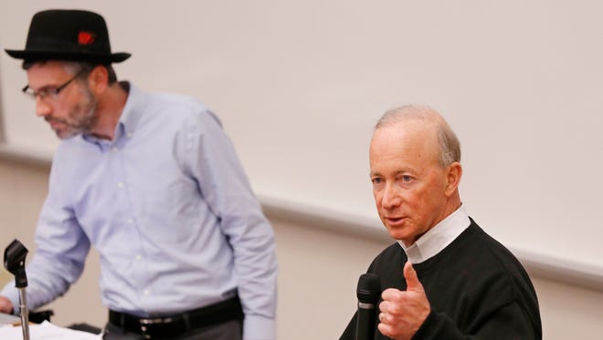 President Mitch Daniels answers question's concerning Purdue planned acquisition of Kaplan University during a special session of the University Senate Thursday, May 4, 2017, in Forney Hall of Chemical Engineering. Listening to Daniels is David Sanders, Chairman of the University Senate.