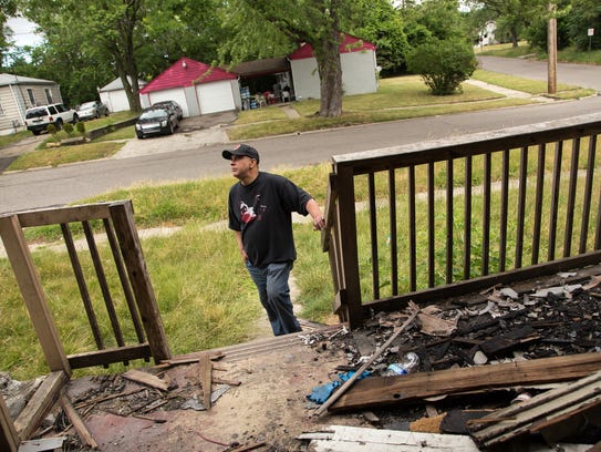 Andre Jackson, of Flint, stands outside of a house