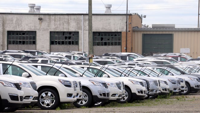 New GM vehicles fill a parking lot on St. Joseph Street in Lansing on June 13, 2014.