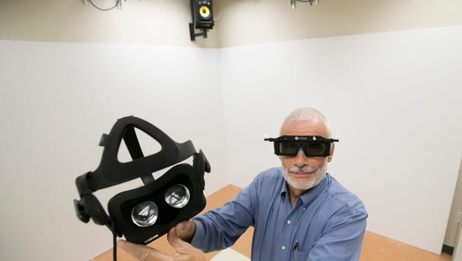 Richard Behr, the dean of the U.A. Whitaker College of Engineering at Florida Gulf Coast University displays glasses and other technology that will be put to use in a virtual reality lab being built at Holmes Hall on the campus. 