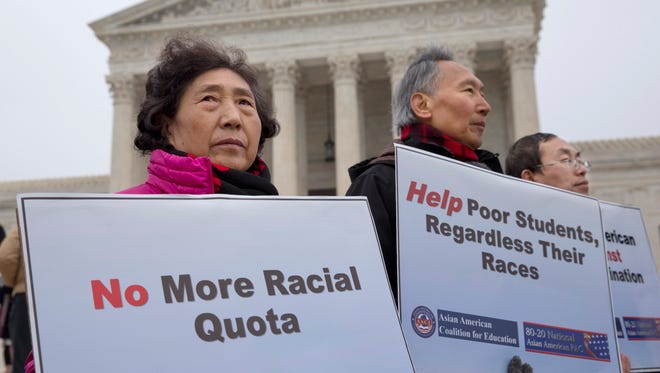Guixue Zhou of North Potomac, Maryland., left, and others protests against racial quotas outside the Supreme Court in 2015, as the court heard oral arguments in the Fisher v. University of Texas at Austin case.