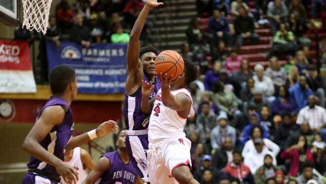 North Central's Emmanuel Little rises up against a Ben Davis' Trevaughn Bush during Friday night's game in Indianapolis.